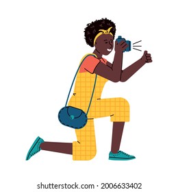 Photographer woman taking picture with camera and giving thumbs up - isolated vector illustration of African girl kneeling and taking photograph on DSLR.