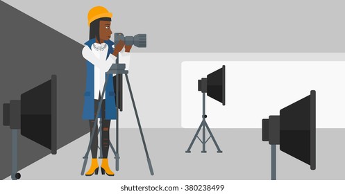 Photographer working with camera on a tripod.