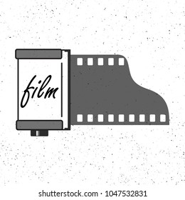 Photographic film cassette icon on grunge background