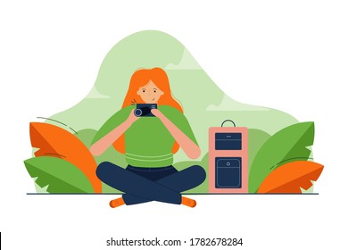 Photography, work, creativity concept. Young happy smiling woman girl cartoon character sitting with camera taking shot picture making photos in studio. Creative professional occupation or hobby.