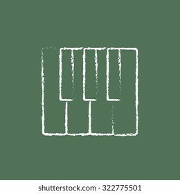 Piano keys hand drawn in chalk on a blackboard vector white icon isolated on a green background.