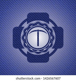 pickaxe icon inside badge with denim background