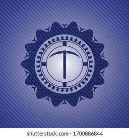 pickaxe icon inside badge with jean texture