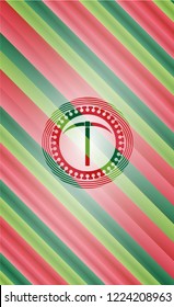 pickaxe icon inside christmas badge background.