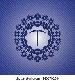 pickaxe icon inside emblem with denim texture