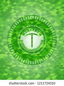 pickaxe icon inside green emblem with triangle mosaic background