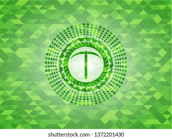 pickaxe icon inside green emblem with triangle mosaic background