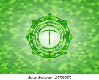 pickaxe icon inside green mosaic emblem