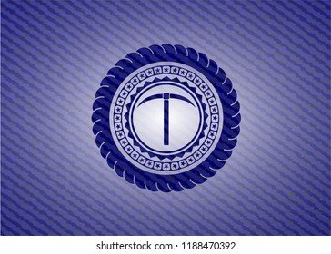 pickaxe icon inside jean or denim emblem or badge background