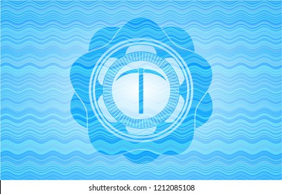 pickaxe icon inside light blue water wave style badge.