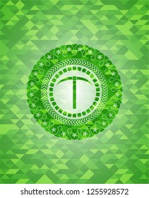 pickaxe icon inside realistic green emblem. Mosaic background