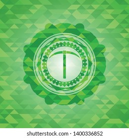 pickaxe icon inside realistic green emblem. Mosaic background