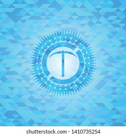 pickaxe icon inside realistic light blue mosaic emblem