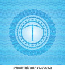 pickaxe icon inside water concept badge background.