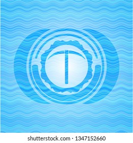 pickaxe icon inside water wave representation emblem.