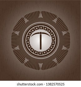 pickaxe icon inside wood badge or emblem