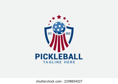 pickleball championship logo with a combination of a shield, an upward-moving pickleball, and stars.
