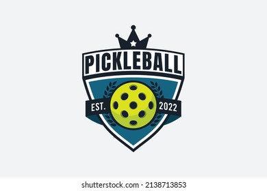 pickleball logo with a combination of a ball, shield and crown.