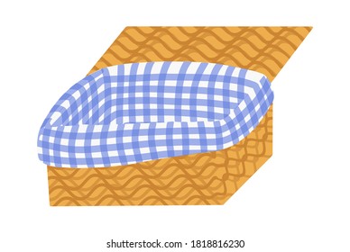 picnic basket made of wicker material, covered with a checkered tablecloth. empty food container for barbecue outdoors.