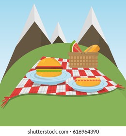 picnic checkered blanket with food and mountains background