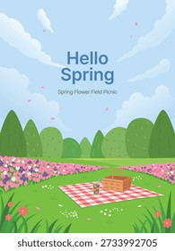Picnic mat and basket on a blooming flower field with green trees in the background