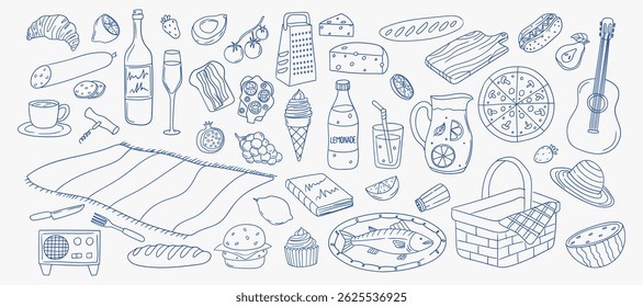 Picnic setup with various foods and items on blanket at outdoor location