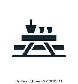 Picnic table with basket and cups representing outdoor dining