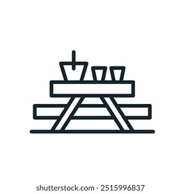 Picnic table setting with drinks and cooler for outdoor dining and camping experience