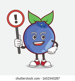A picture of blueberry cartoon mascot character rise up a warning sign
