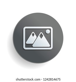 Picture with couple of mountains and sun. Simple icon. White paper symbol on gray round button or badge with shadow