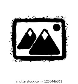 Picture with couple of mountains and sun. Simple icon. Black ink with splashes on white background