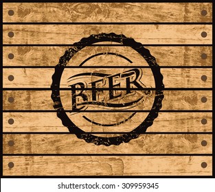 picture of the cover of a bottle of beer on a wooden box