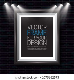 Picture frame on a brick wall background illuminated by spotlights. Vector template for your presentations.