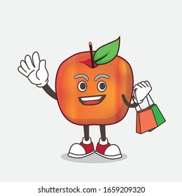A picture of Honeycrisp Apple cartoon mascot character waving and holding Shopping bag