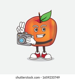 A picture of Honeycrisp Apple cartoon mascot character as photographer in action with a camera