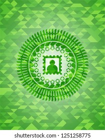 picture icon inside green emblem with mosaic ecological style background
