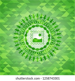 picture icon inside green emblem with mosaic ecological style background