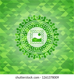 picture icon inside green emblem. Mosaic background