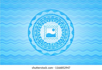 picture icon inside light blue water wave emblem background.
