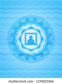 picture icon inside light blue water wave badge.