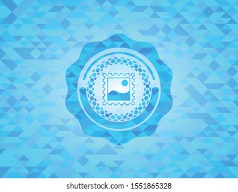 picture icon inside light blue mosaic emblem