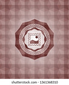 picture icon inside red seamless emblem with geometric pattern background.