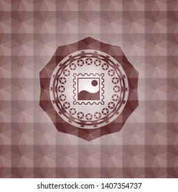 picture icon inside red seamless emblem or badge with geometric pattern background.