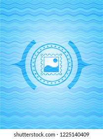 picture icon inside sky blue water wave emblem.