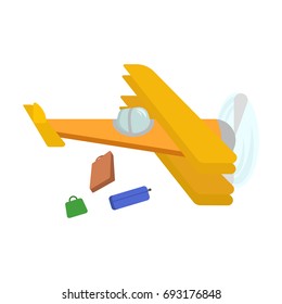 Picture of an isolated yellow plane from which suitcases fall