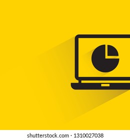 pie chart in laptop with shadow on yellow background