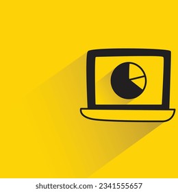 pie chart in laptop with shadow on yellow background