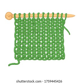A piece of fabric knitted on knitting needles on a white background.