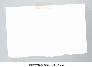 Piece of torn white note paper with long shadow