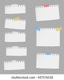 Pieces of cut out white notebook paper are stuck on gray striped background